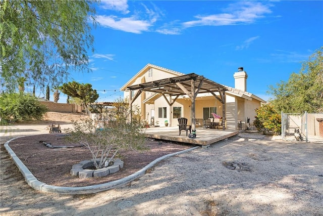 rear view of house featuring a pergola