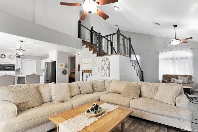 living room with dark hardwood / wood-style floors and high vaulted ceiling