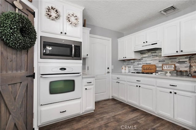 kitchen with white cabinetry, dark hardwood / wood-style flooring, and stainless steel appliances