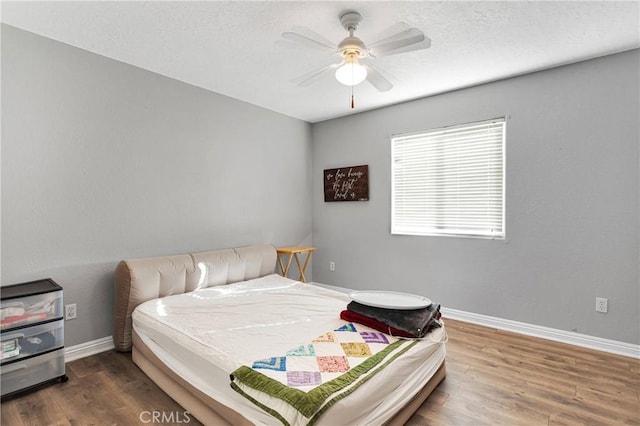 bedroom featuring hardwood / wood-style floors and ceiling fan