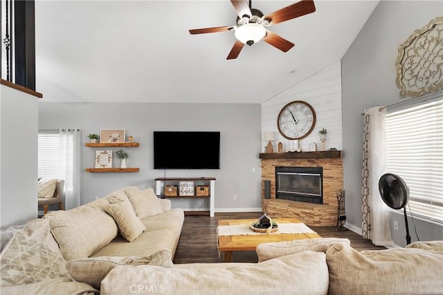 living room with dark hardwood / wood-style floors, high vaulted ceiling, ceiling fan, and a stone fireplace