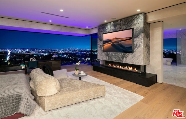 home theater room featuring wood-type flooring and a fireplace