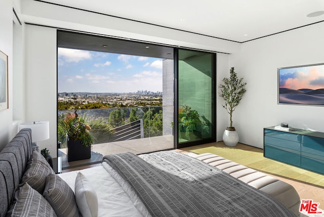 bedroom featuring light hardwood / wood-style flooring and access to exterior