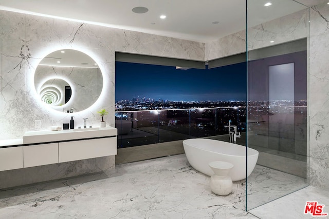 bathroom with vanity, tile walls, and a bath