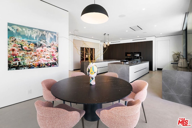 dining room featuring an inviting chandelier and sink