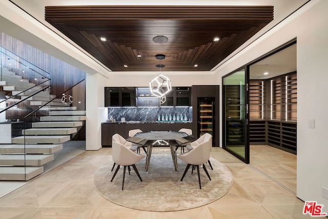 dining area with light parquet flooring, wood ceiling, and a tray ceiling