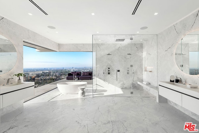 bathroom with vanity, tile walls, separate shower and tub, and a wealth of natural light