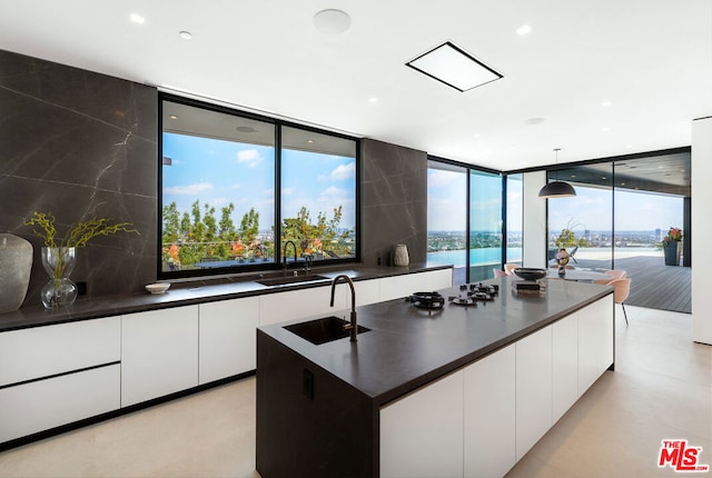 kitchen featuring pendant lighting, a center island, sink, and a wealth of natural light