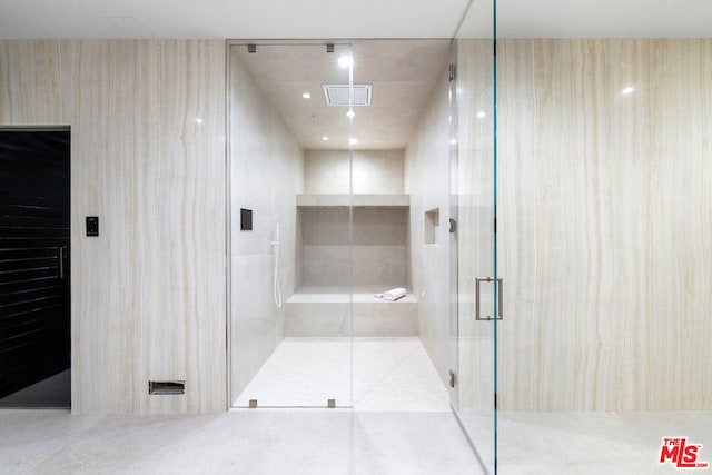 bathroom featuring a shower with door