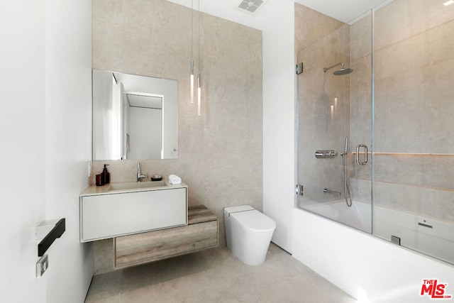 full bathroom featuring shower / bath combination with glass door, vanity, toilet, and concrete floors