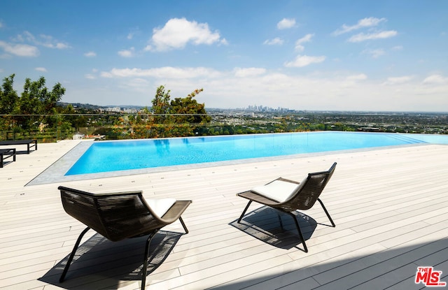 view of swimming pool with a deck