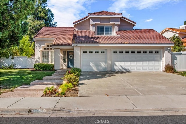 mediterranean / spanish-style house featuring a front lawn and a garage