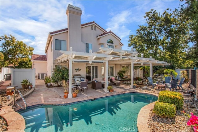 rear view of property featuring a pergola, cooling unit, an outdoor living space with a fire pit, a fenced in pool, and a patio area