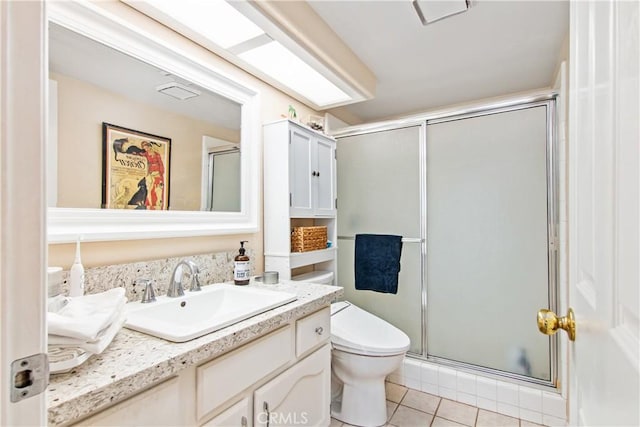 bathroom with toilet, vanity, tile patterned floors, and an enclosed shower