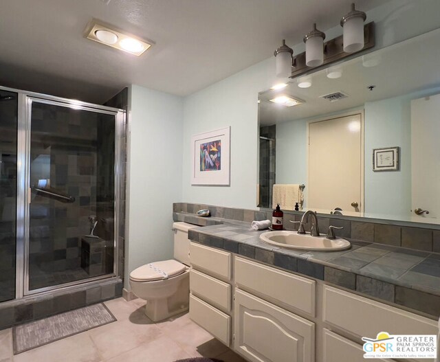 bathroom with toilet, walk in shower, tile patterned floors, and vanity