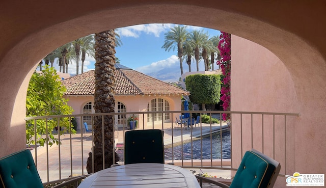 balcony featuring a patio area and a water view