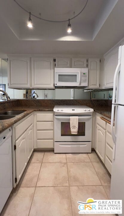 kitchen featuring white cabinetry, white appliances, and a tray ceiling