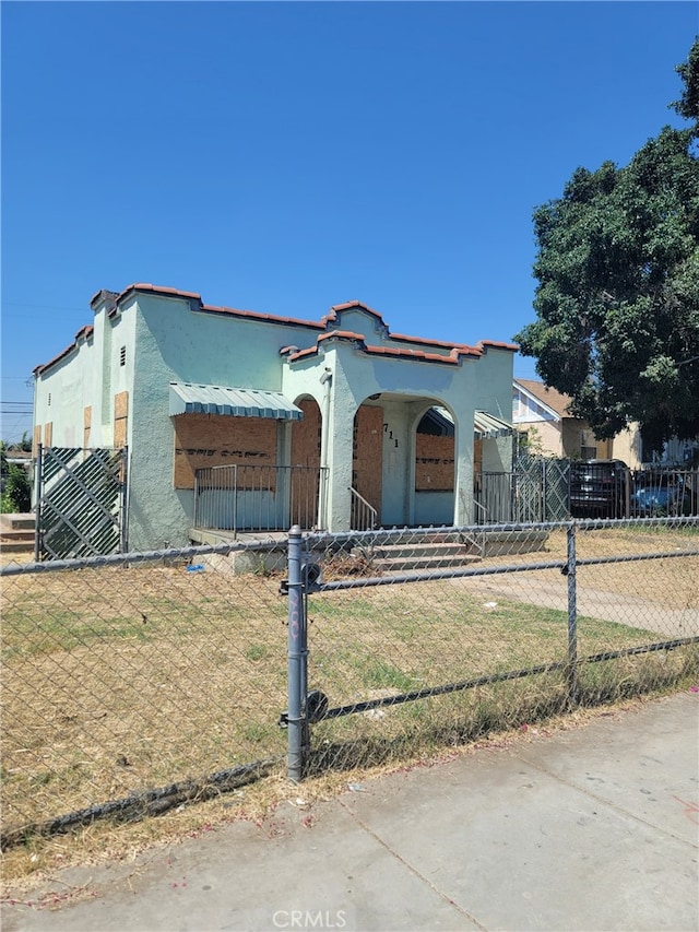 mediterranean / spanish house with a front yard