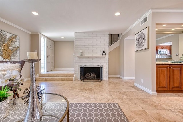 living room featuring a fireplace, light tile patterned floors, and crown molding