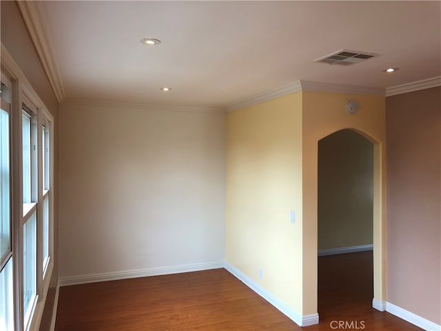 unfurnished room with ornamental molding and dark hardwood / wood-style flooring