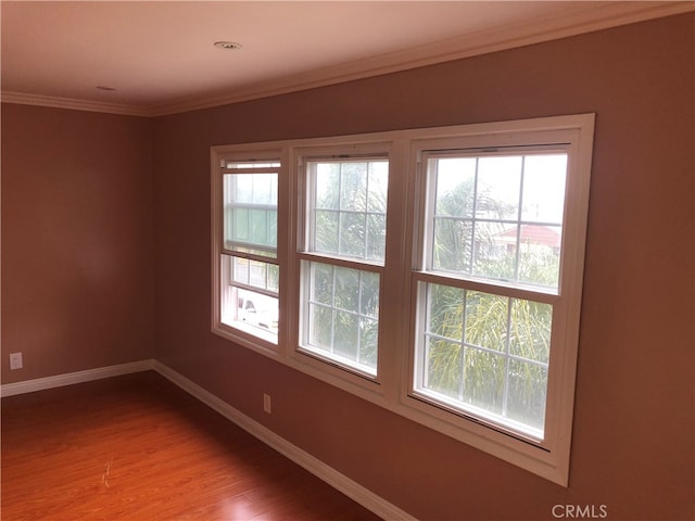 unfurnished room featuring ornamental molding and hardwood / wood-style floors