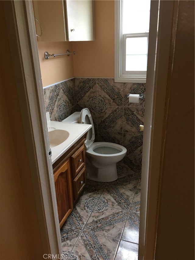 bathroom featuring tile patterned flooring, vanity, and toilet