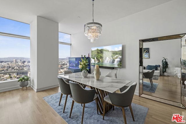 dining space featuring a notable chandelier and light wood-type flooring