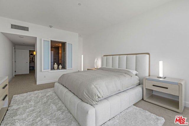 bedroom with light colored carpet