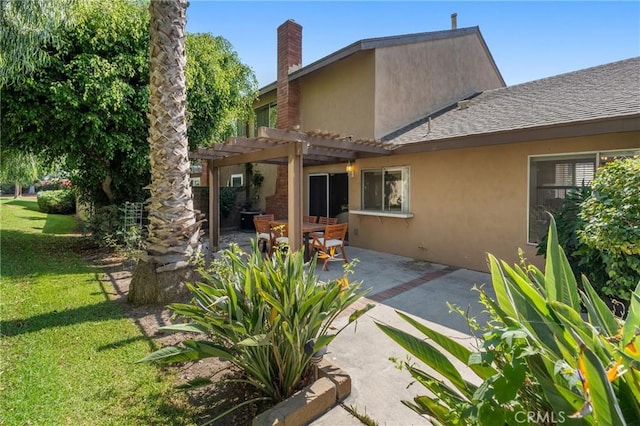 back of property with a lawn, a pergola, and a patio