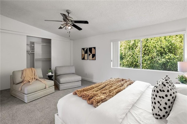 bedroom featuring a textured ceiling, ceiling fan, a closet, and vaulted ceiling