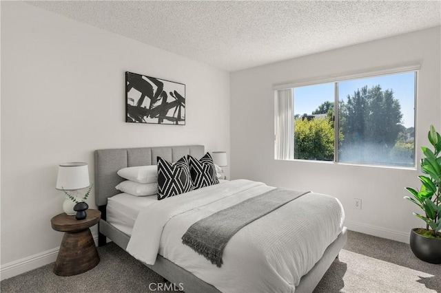 carpeted bedroom featuring a textured ceiling