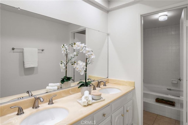 bathroom with tile patterned floors, vanity, and tiled shower / bath