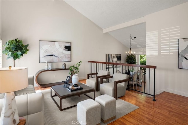 sitting room with a chandelier, beamed ceiling, high vaulted ceiling, and wood-type flooring