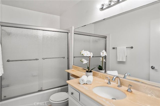 full bathroom with toilet, combined bath / shower with glass door, and vanity