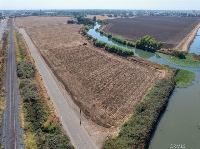 birds eye view of property featuring a rural view and a water view