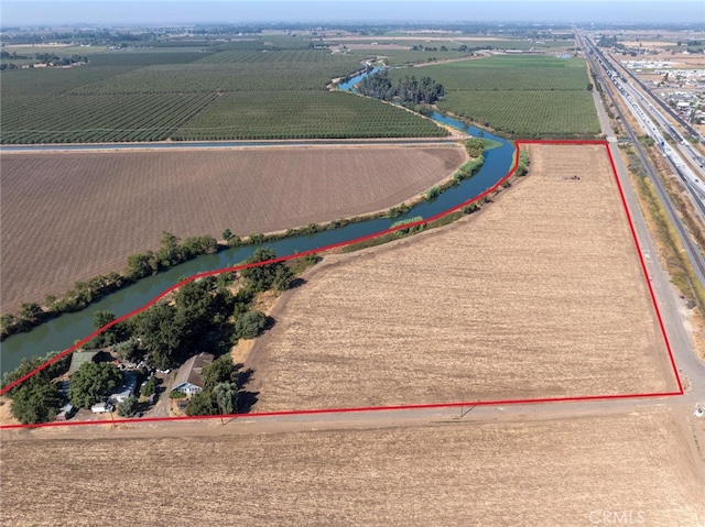 drone / aerial view featuring a rural view and a water view