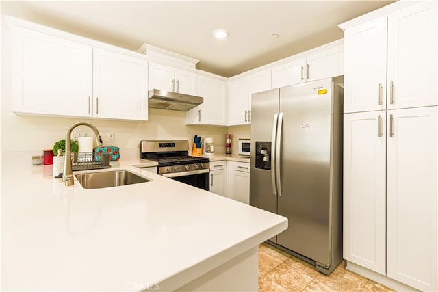 kitchen with appliances with stainless steel finishes, sink, light tile patterned floors, and white cabinets