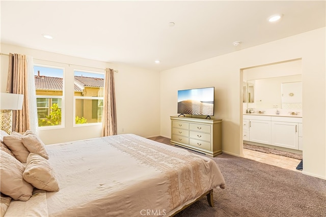 carpeted bedroom featuring ensuite bath