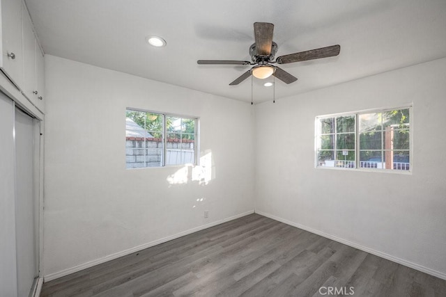 unfurnished room featuring ceiling fan and dark wood-type flooring