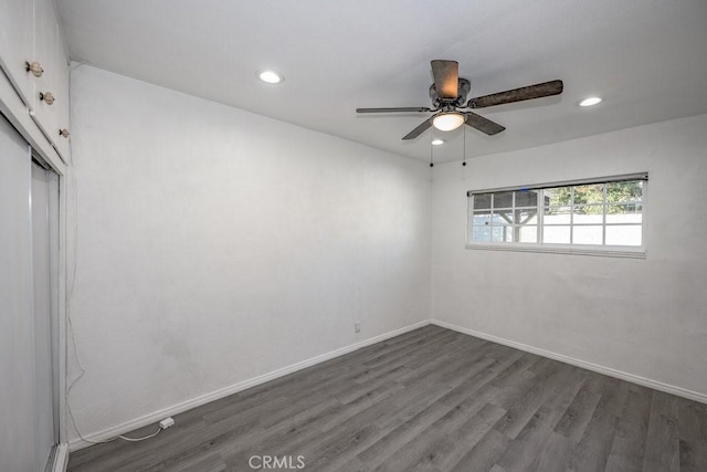 spare room with ceiling fan and dark hardwood / wood-style floors