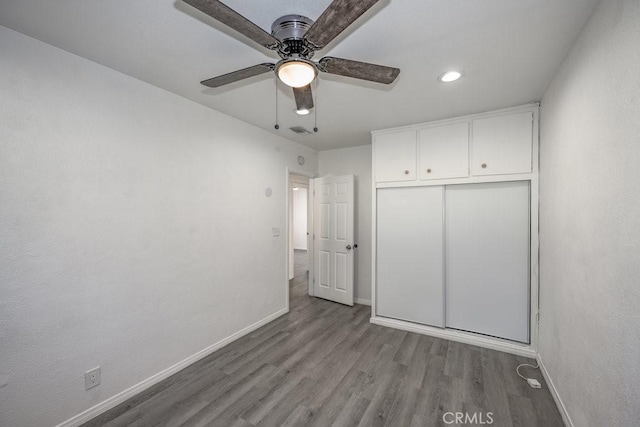 unfurnished bedroom with ceiling fan, a closet, and light hardwood / wood-style flooring