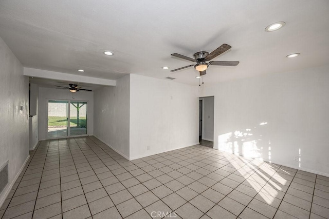 tiled empty room featuring ceiling fan