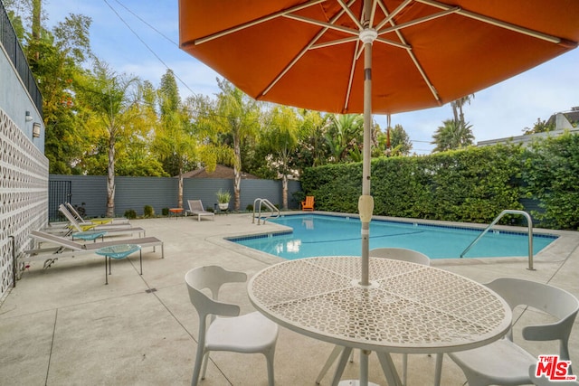 view of swimming pool with a patio area