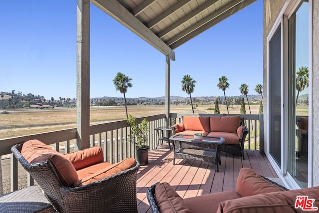 wooden terrace featuring a rural view