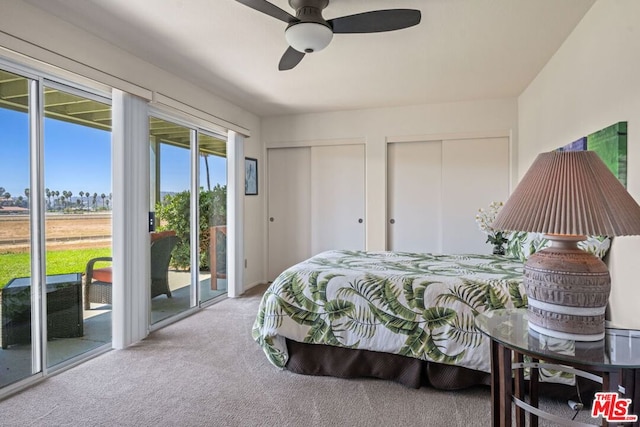 bedroom featuring ceiling fan, access to exterior, light carpet, and two closets