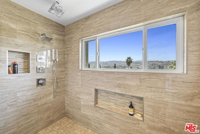 bathroom with a tile shower