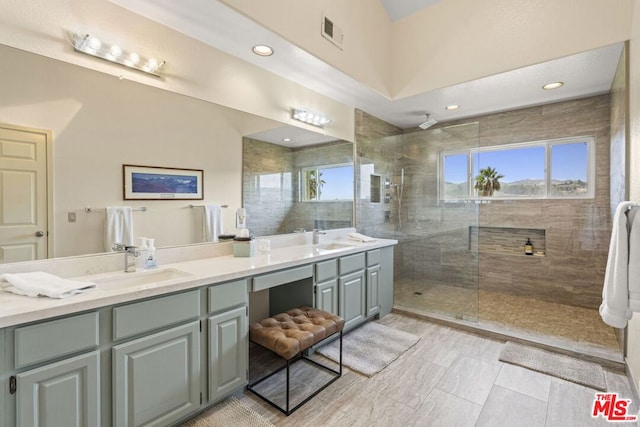 bathroom featuring vanity and tiled shower