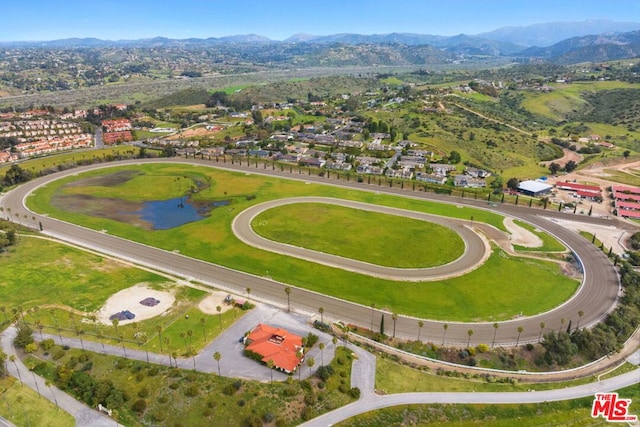 birds eye view of property with a water and mountain view