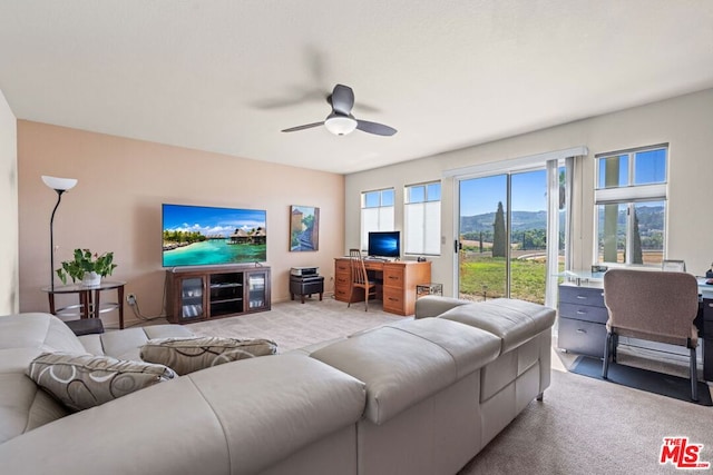 living room featuring ceiling fan and light colored carpet