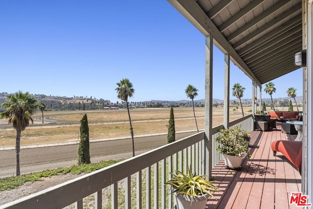 wooden terrace featuring a rural view